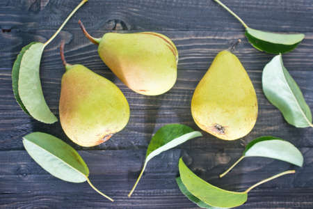 fresh pears and leaves on the wooden tableの写真素材