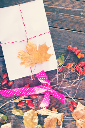 envelope on the wooden background,envelopes and autumn leavesの写真素材
