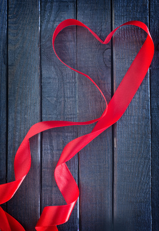 red heart ribbon on the wooden backgroundの写真素材