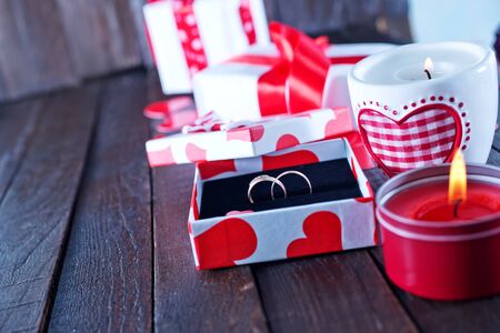 present for valentines day in the box and candle on a tableの写真素材