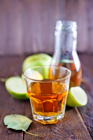 fresh apple juice in the glass and on a tableの写真素材