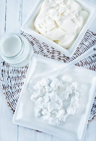 milk products in bowl and on a tableの写真素材