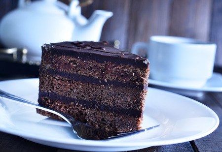 chocolate cake on white plate and on a tableの写真素材