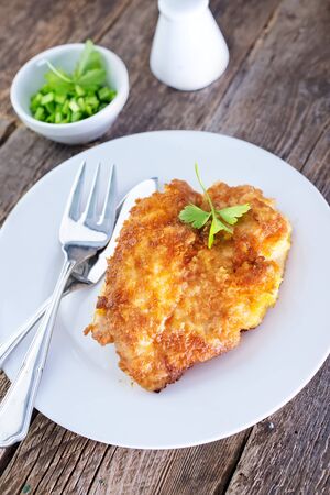 chicken breast on plate and on a tableの写真素材