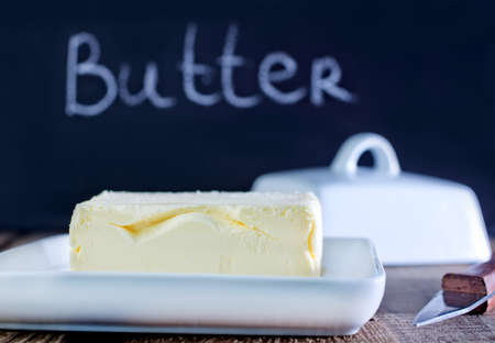 butter on white plate and on a tableの写真素材