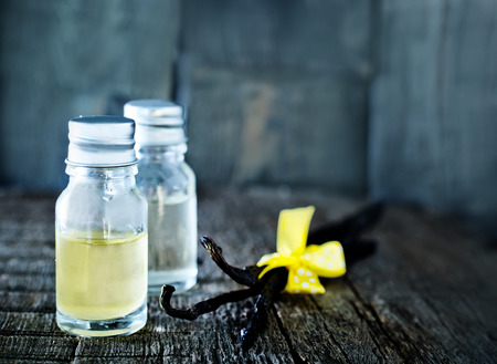aroma oil in glass bowl and on a tableの写真素材