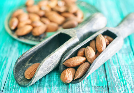 almond in spoon and on a tableの写真素材