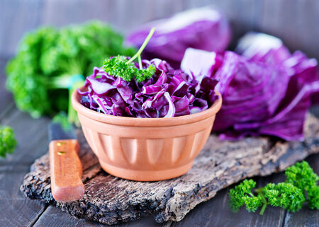 blue cabbage in bowl and on a tableの写真素材