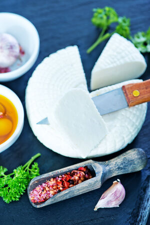 cheese with olives and oil in bowlの写真素材