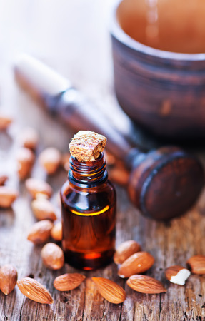 almond oil in a glass bottle with whole nutsの写真素材