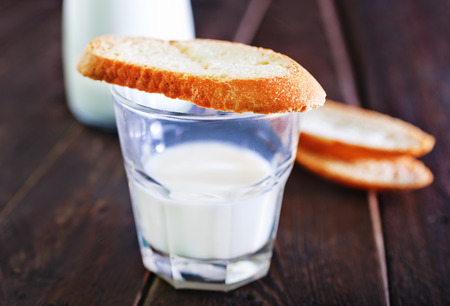 fresh milk in glass and on a tableの写真素材