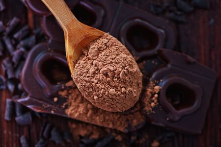 chocolate and cocoa powder on the wooden tableの写真素材