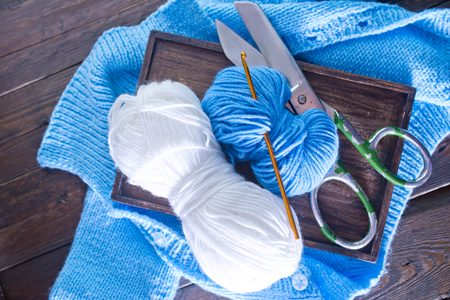 blue threads for knitting on the wooden tableの写真素材