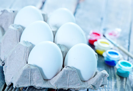 white eggs and paint on a table