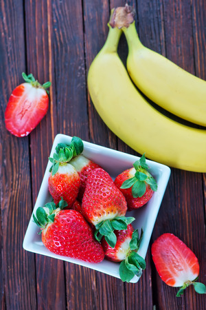 banana and strawberry on the wooden tableの写真素材