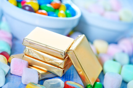 color candy in bowl and on a tableの写真素材