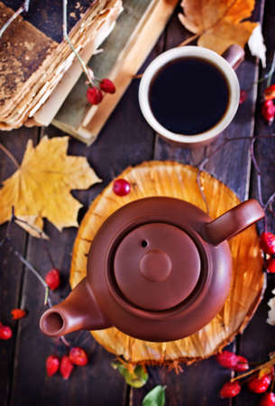 fresh tea in teapot on wooden board and on a tableの写真素材
