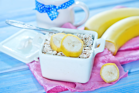 oat flakes with banana in the bowlの写真素材