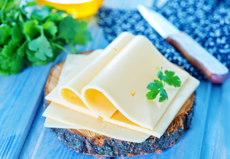 cheese and fresh parsley on a tableの写真素材