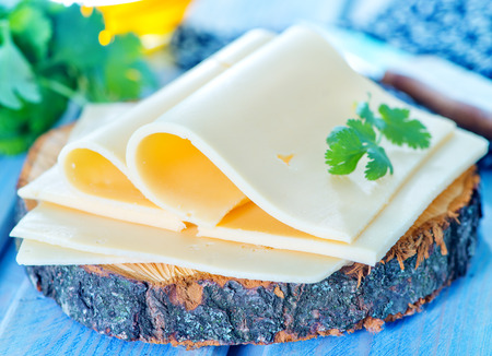 cheese and fresh parsley on a tableの写真素材