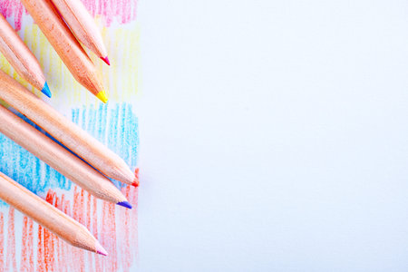 color pencils and paper on the wooden table