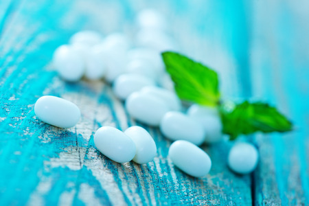 mint candy with mint leaf on a tableの写真素材
