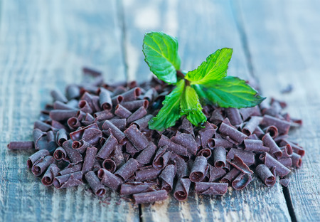 chocolate candy with mint leaf on the wooden tableの写真素材