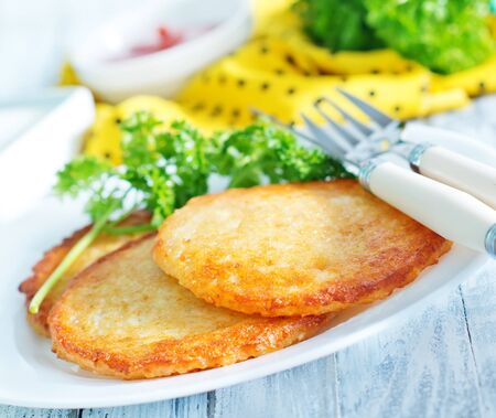 potato pancakes on plate and on a tableの写真素材