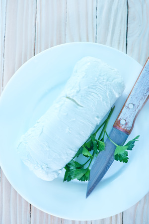 mozzarella on white plate and on a tableの写真素材