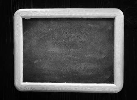 black board and white chalk on a table