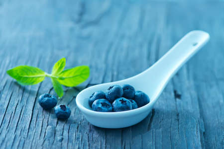 fresh blueberry on the wooden board, berries on a tableの写真素材