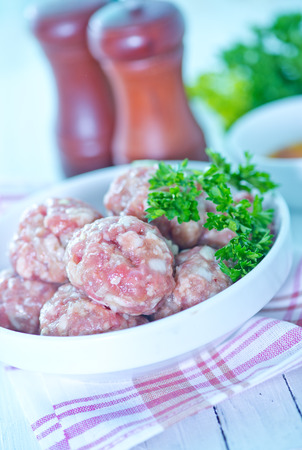 meat balls in bowl and on a tableの写真素材