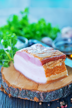 smoked lard with spice on the wooden boardの写真素材