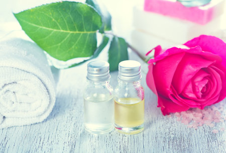 rose oil in bottle and on a tableの写真素材
