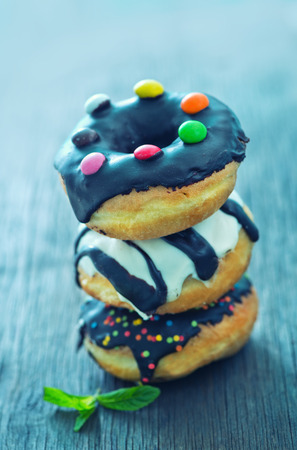 sweet donuts on the wooden background, fresh donutsの写真素材