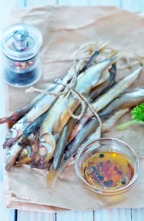 smoked fish on paper and on a tableの写真素材