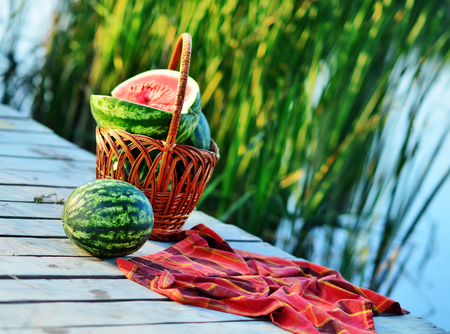 fresh watermelon on the wooden pier, pier on lakeの写真素材