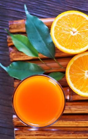 orange juice in glass and on a tableの写真素材