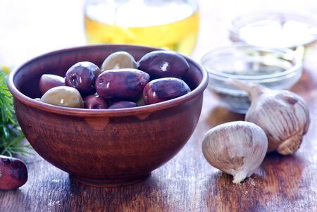 olives and olive oil on a tableの写真素材