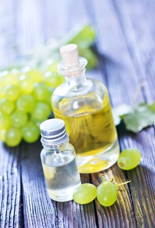 grape oil in bottle and on a tableの写真素材