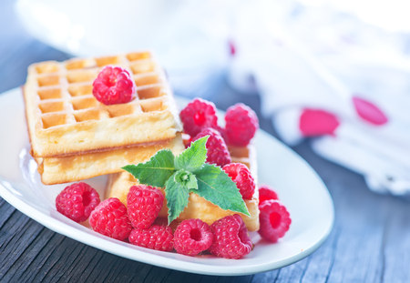 belgium wafer with fresh raspberry on the plateの写真素材