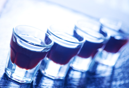 coffee liquor into small glasses and on a tableの写真素材