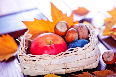 autumn background, autumn apples and leaves on a tableの写真素材