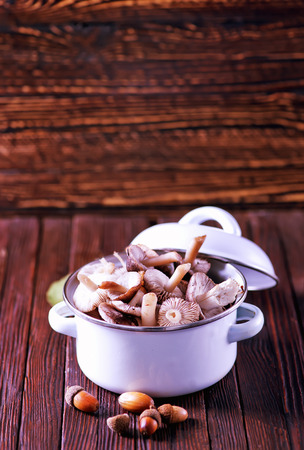 mushrooms in bowl and on a tableの写真素材