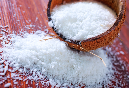 dry coconut on the wooden table, grated coconutの写真素材