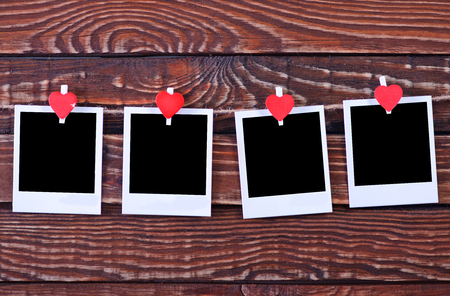 Blank instant photo and red hearts on wooden backgroundの写真素材