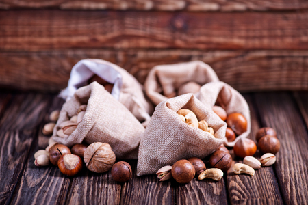 different kind of nuts on the wooden tableの写真素材