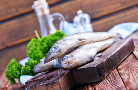 raw fish on wooden board and on a table