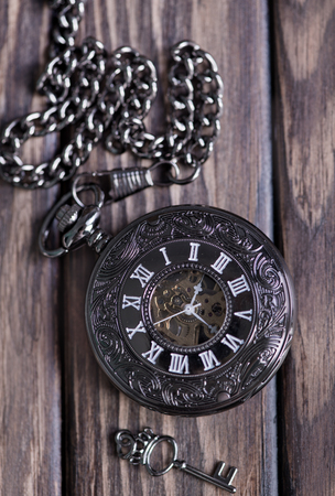 Vintage pocket watch and hour glass or sand timer, symbols of time with copy spaceの写真素材