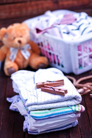 Clear baby clothes on the wooden tableの写真素材